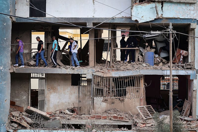 Venezuelans pick through the damage in Caracas the day after US forces captured Maduro