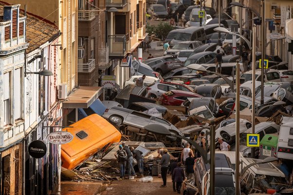 Cars piled in a street after flash floods hit the Sedaví area in Valencia, October 2024