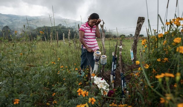 Julia Francisco Martínez stands at the graveside of her husband Juan, a Honduran Indigenous defender who was found murdered in 2015.