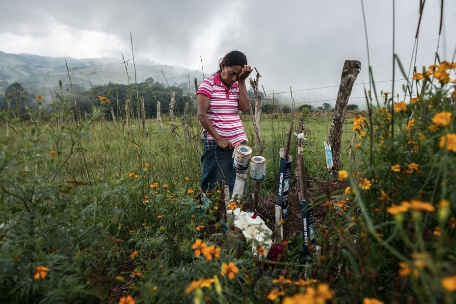 Julia Francisco Martínez stands at the graveside of her husband Juan, a Honduran Indigenous defender who was found murdered in 2015.