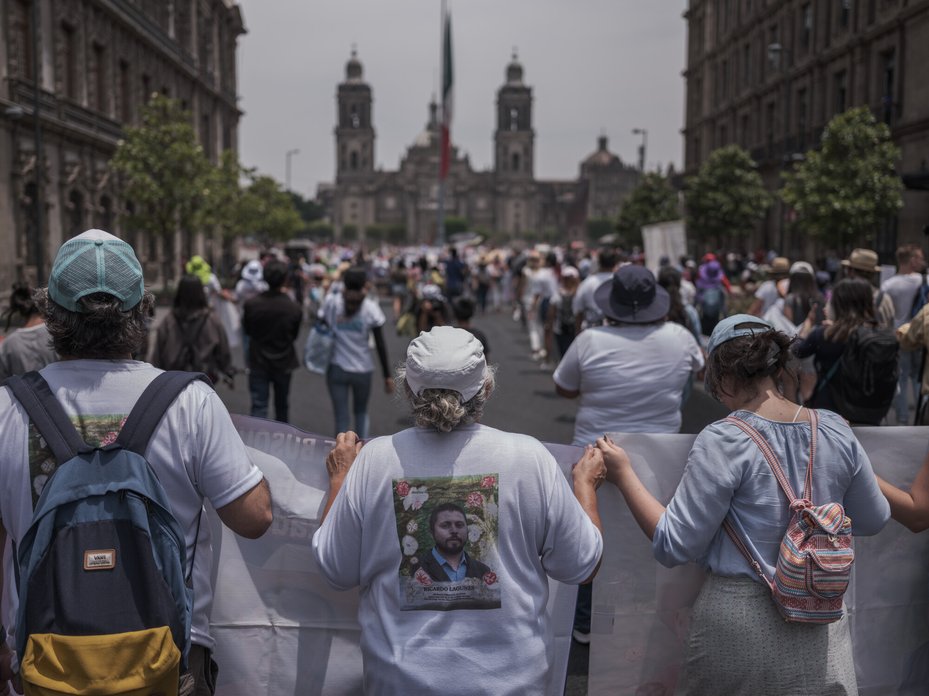 Ana Lucia Gasca Boyer, mother of disappeared human rights lawyer Ricardo Lagunes, walks with her family during a protest for disappeared people in the centre of Mexico City