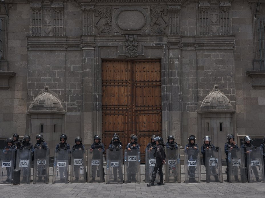 Mexican police guard the National Palace during a protest in commemorating the disappeared in the centre of Mexico City.