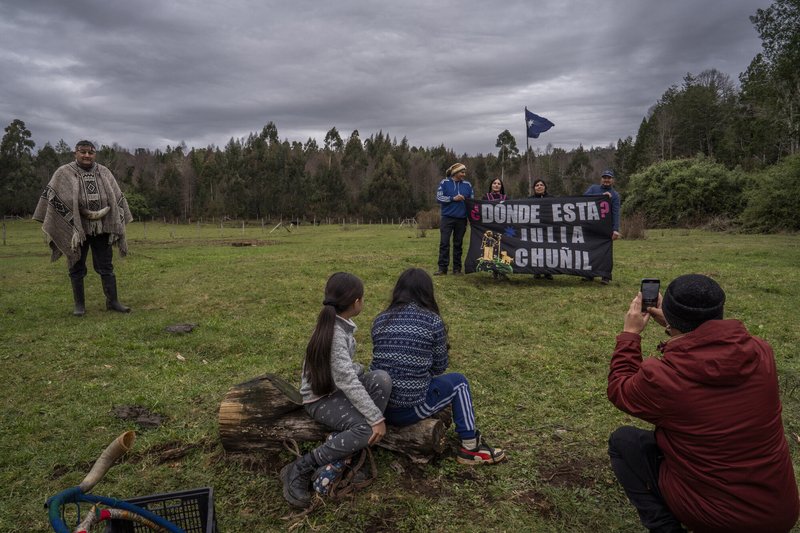 Family members and friends of Julia Chuñil display a banner that reads: “Where is Julia Chuñil?” on the land where she was last seen