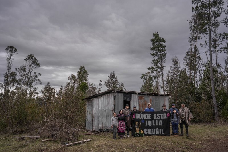 Family members and friends of Julia Chuñil display a banner that reads: “Where is Julia Chuñil?” on the land where she was last seen