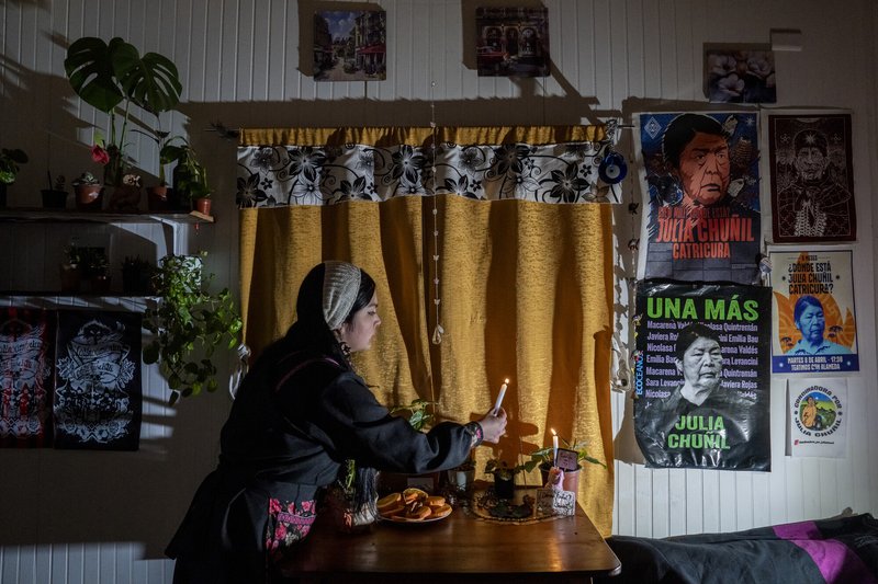 Lissette Chuñil makes a offering to honour her grandmother – a Mapuche woman and president of the Indigenous community of Máfil, who was disappeared in November 2024