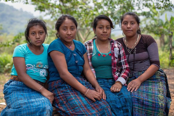 four Indigenous women from the Ixquisis community in Guetemala sit together